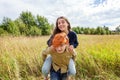 Summer holidays vacation happy people concept. Loving couple having fun in nature outdoors. Happy young man piggybacking Royalty Free Stock Photo