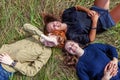 Summer holidays vacation happy people concept. Top view group of three friends lying on grass in circle smiling and having fun Royalty Free Stock Photo