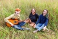 Summer holidays vacation music happy people concept. Group of three friends boy and two girls with guitar singing song having fun Royalty Free Stock Photo