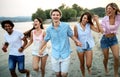 Group of friends having fun on the beach. Summer holidays, vacation and people concept. Royalty Free Stock Photo