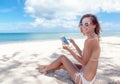 summer holidays, vacation, technology and internet - girl looking at tablet pc on the beach chair Royalty Free Stock Photo