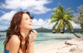 Happy woman enjoying sun on tropical beach Royalty Free Stock Photo