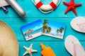 Summer holidays and vacation travel concept. Sunscreen lotion bottle, straw hat, flip flops, starfish, life buoy, plane and Royalty Free Stock Photo