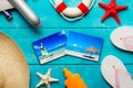 Summer holidays and vacation travel concept. Sunscreen lotion bottle, straw hat, flip flops, starfish, life buoy, plane and Royalty Free Stock Photo