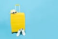 Summer holidays, vacation and travel concept.Yellow Suitcase or luggage bag,white sneakers and fashion sunglasses on sun hat Royalty Free Stock Photo