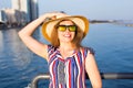 Summer holidays, vacation, travel and people concept - smiling laughing young woman wearing sunglasses and hat on beach Royalty Free Stock Photo