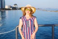 Summer holidays, vacation, travel and people concept - smiling young woman wearing sunglasses and hat on beach over sea Royalty Free Stock Photo