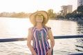 Summer holidays, vacation, travel and people concept - smiling young woman wearing sunglasses and hat on beach over sea Royalty Free Stock Photo