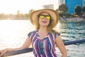 Summer holidays, vacation, travel and people concept - smiling young woman wearing sunglasses and hat on beach over sea Royalty Free Stock Photo