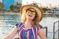 Summer holidays, vacation, travel and people concept - smiling young woman wearing sunglasses and hat on beach over sea Royalty Free Stock Photo