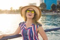 Summer holidays, vacation, travel and people concept - smiling young woman wearing sunglasses and hat on beach over sea Royalty Free Stock Photo