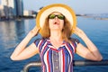 Summer holidays, vacation, travel and people concept - smiling young woman wearing sunglasses and hat on beach over sea Royalty Free Stock Photo