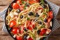 Summer homemade greek pasta salad with cheese, olives, tomatoes close-up on a plate. Horizontal top view