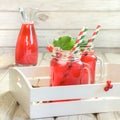 Summer homemade red currant lemonade in a mason jar with decor of berry in tray on rustic table. Close up. Royalty Free Stock Photo