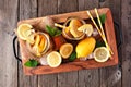 Summer iced tea top view in a wooden serving tray over rustic wood