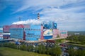 Summer industrial landscape - Arkhangelsk Pulp and Paper Mill, central watch, white smoke from the pipes against the blue sky, Royalty Free Stock Photo