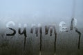 Summer inscription on the texture with condensation on the glass.