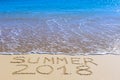 Summer 2018 inscription on wet beach sand Royalty Free Stock Photo