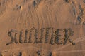 Summer inscription written on a sand