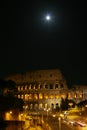 Night Colosseum with illumination. The moon in the sky