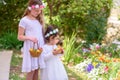 Summer, Jewish Holiday Shavuot.Harvest.Two little girls in white dress holds a basket with fresh fruit in a garden. Royalty Free Stock Photo