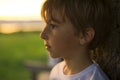 Summer joy for cute kid at the backlit sunset Royalty Free Stock Photo