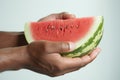 Summer joy mens hands embrace a watermelon on white canvas