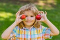 Summer kid face. Kid picking and eating ripe strawberry. Happy child holding fresh fruits berry strawberry. Healthy Royalty Free Stock Photo