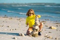 Summer kid meditation. Child boy with balanced stone pebble pyramid on the beach. Child play with zen stones on the sea Royalty Free Stock Photo