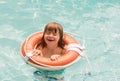 Summer kid vacation. Summertime child weekend. Boy in swiming pool. Toddler at aquapark on inflatable rubber circle. Royalty Free Stock Photo