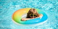 Summer kid vacation. Summertime weekend. Boy in swiming pool. Child at aquapark. Funny boy on inflatable rubber circle. Royalty Free Stock Photo