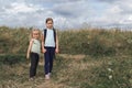 Two children among tall grass in the field Royalty Free Stock Photo