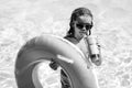 Summer kids Cocktail. Happy little boy with colorful inflatable ring in outdoor swimming pool on hot summer day. Family Royalty Free Stock Photo