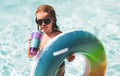 Summer kids Cocktail. Happy little boy with colorful inflatable ring in outdoor swimming pool on hot summer day. Family Royalty Free Stock Photo