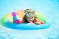 Summer kids cocktail party. Portrait of cute kid in swimming pool, relax swim on inflatable ring and has fun in water on Royalty Free Stock Photo