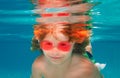 Summer kids face. Young boy swim and dive underwater. Under water portrait in swim pool. Child boy diving into a Royalty Free Stock Photo