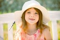 Summer kids girl outdoor, child cute face. Cute little girl swinging on the meadow in summer day.