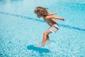 Summer kids holidays. Happy child jump in the sea. Kids jumping on swimming pool. Royalty Free Stock Photo