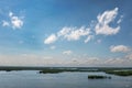 Summer Lake with Boats and Water Skiers Under Cloudy Blue Sky Royalty Free Stock Photo