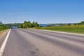 Summer landscape. Asphalt road leading to the river Royalty Free Stock Photo