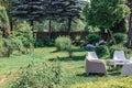 Summer landscape, backyard, lots of greenery, table and chairs, a place for rest