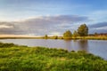 Summer landscape on the banks of the green river at sunset, Russia, Royalty Free Stock Photo