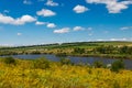 Summer landscape with beautiful lake, green meadows, hills, trees and blue sky Royalty Free Stock Photo