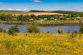 Summer landscape with beautiful lake, green meadows, hills, trees and blue sky Royalty Free Stock Photo