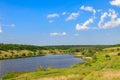 Summer landscape with beautiful lake, green meadows, hills, trees and blue sky Royalty Free Stock Photo