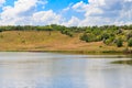 Summer landscape with beautiful lake, green meadows, hills, trees and blue sky Royalty Free Stock Photo