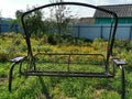 Iron swings, flowers in summer garden Royalty Free Stock Photo