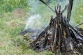 Burning big bonfire and a shamanic tambourine nearby, close-up.