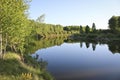Summer landscape - A calm flat river among fields and birch groves under a blue sky. Cloudless summer weather Royalty Free Stock Photo