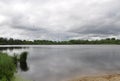 metal cell towers on the bank of a pond outside the city